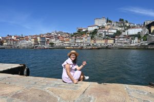 Sentada frente al Duero con la ciudad de Oporto al otro lado del río